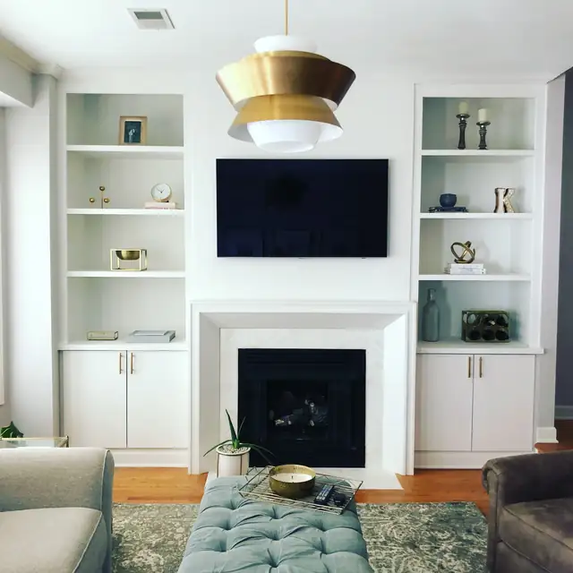 Bucktown Chicago living room with custom white built-in shelves and cabinets flanking a fireplace